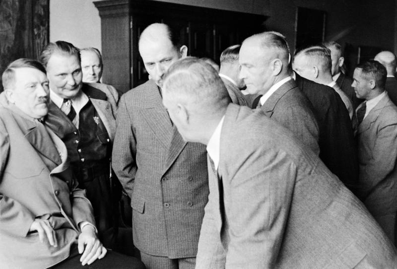 Conference in civil, Adolf Hitler in conversation with senior German officers gathered in the Great Hall of the Berghof